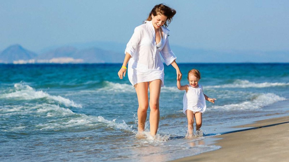 Jeune mère avec ses filles sur la plage